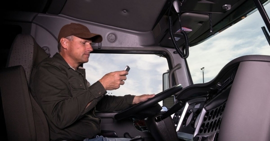 truck looking at his phone while driving